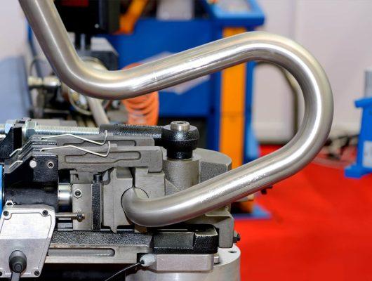 Industrial machine for bending steel pipes and metal rods. Pipe bending machine